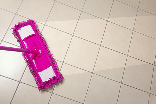 cleaning the tiled floor with purple mop