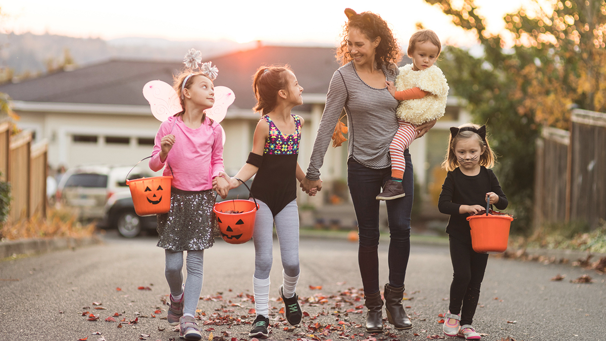 Mom trick or treating with young kids