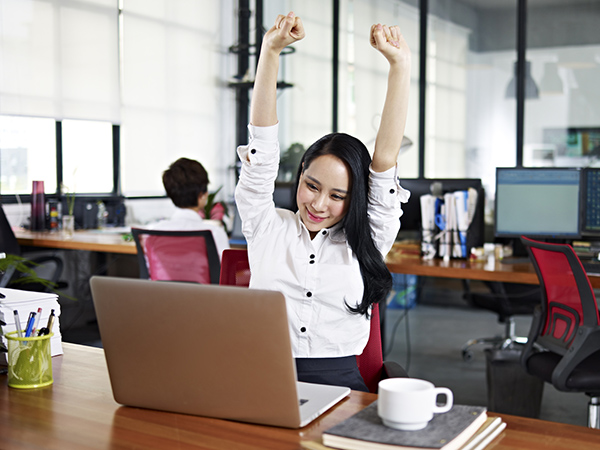 Businesswoman Stretching Arms in Air