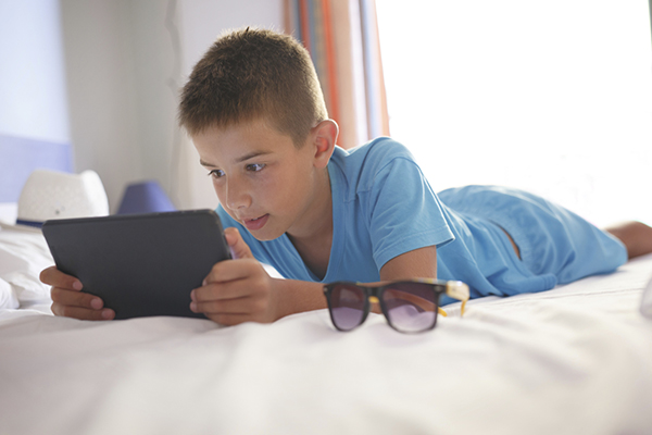 Boy reading on a tablet or iPad