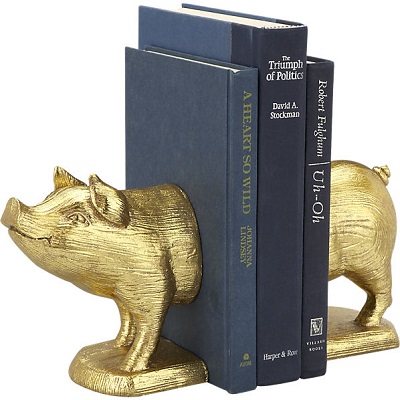 Gold pig bookends holding a blue book
