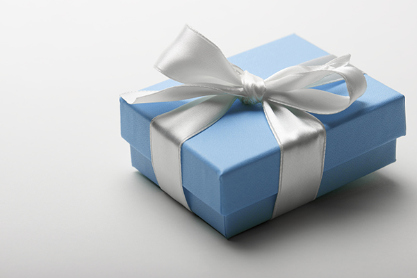 Blue box wrapped with white ribbon gift present