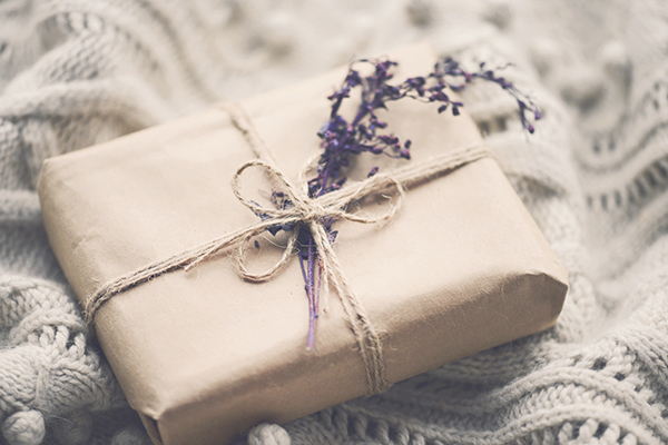 Paper wrapped gift with sprig of lavender
