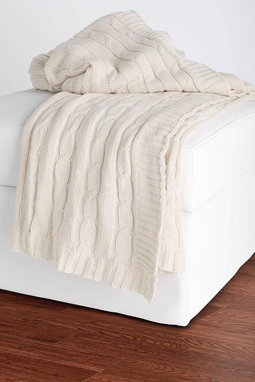 Cream throw blanket on bed