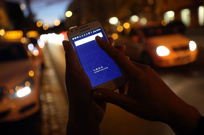 woman uses the Uber app on an Samsung smartphone 