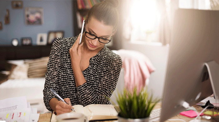 Woman in glasses working in home office