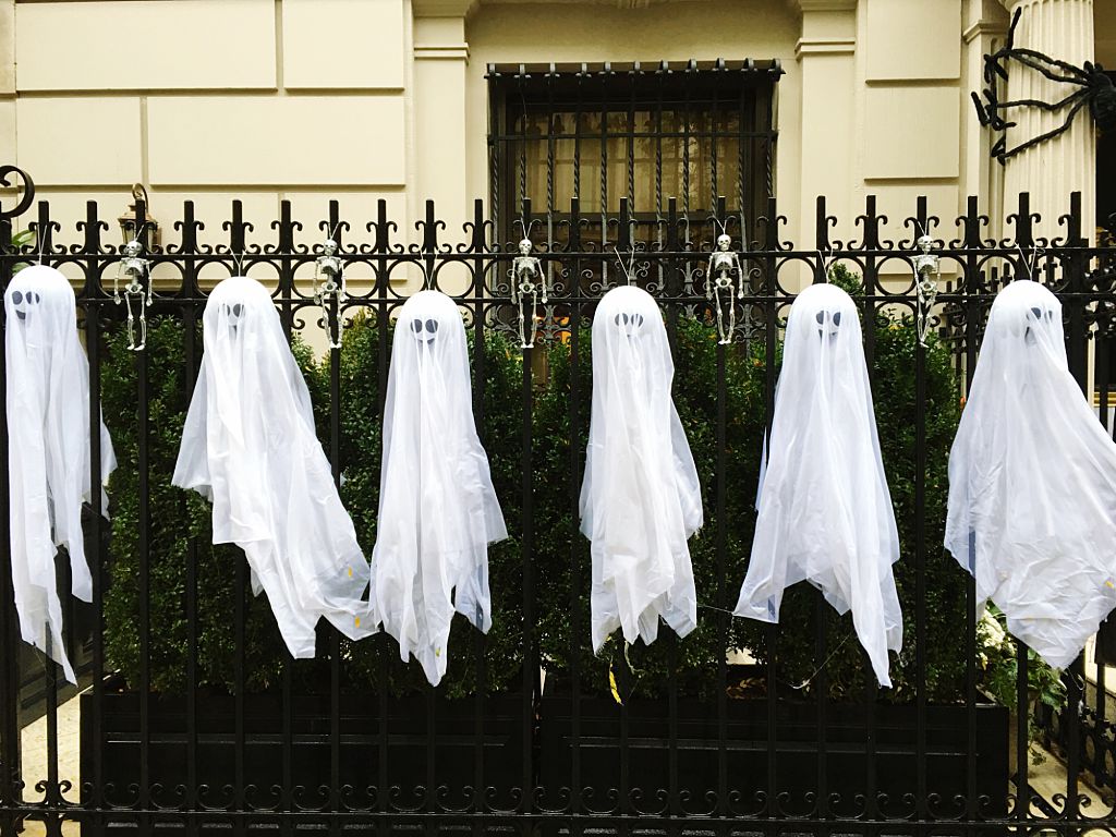 Artificial Ghosts Hanging On Fence Outside House