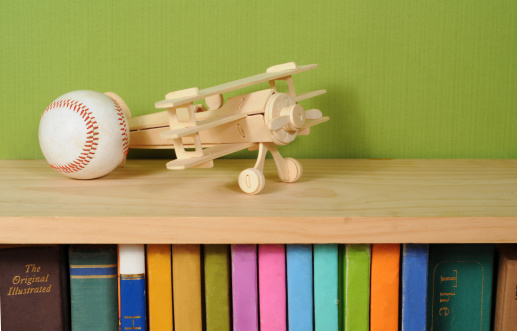 Wooden model airplane on top of book shelf