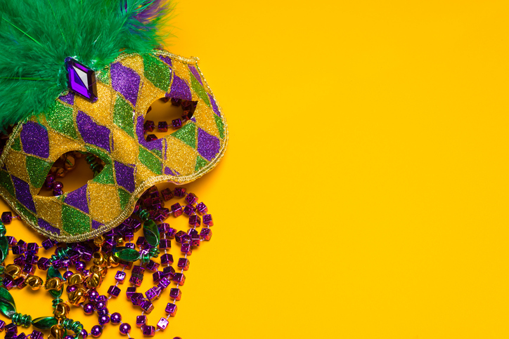 Colorful Mardi Gras or venetian mask on a yellow