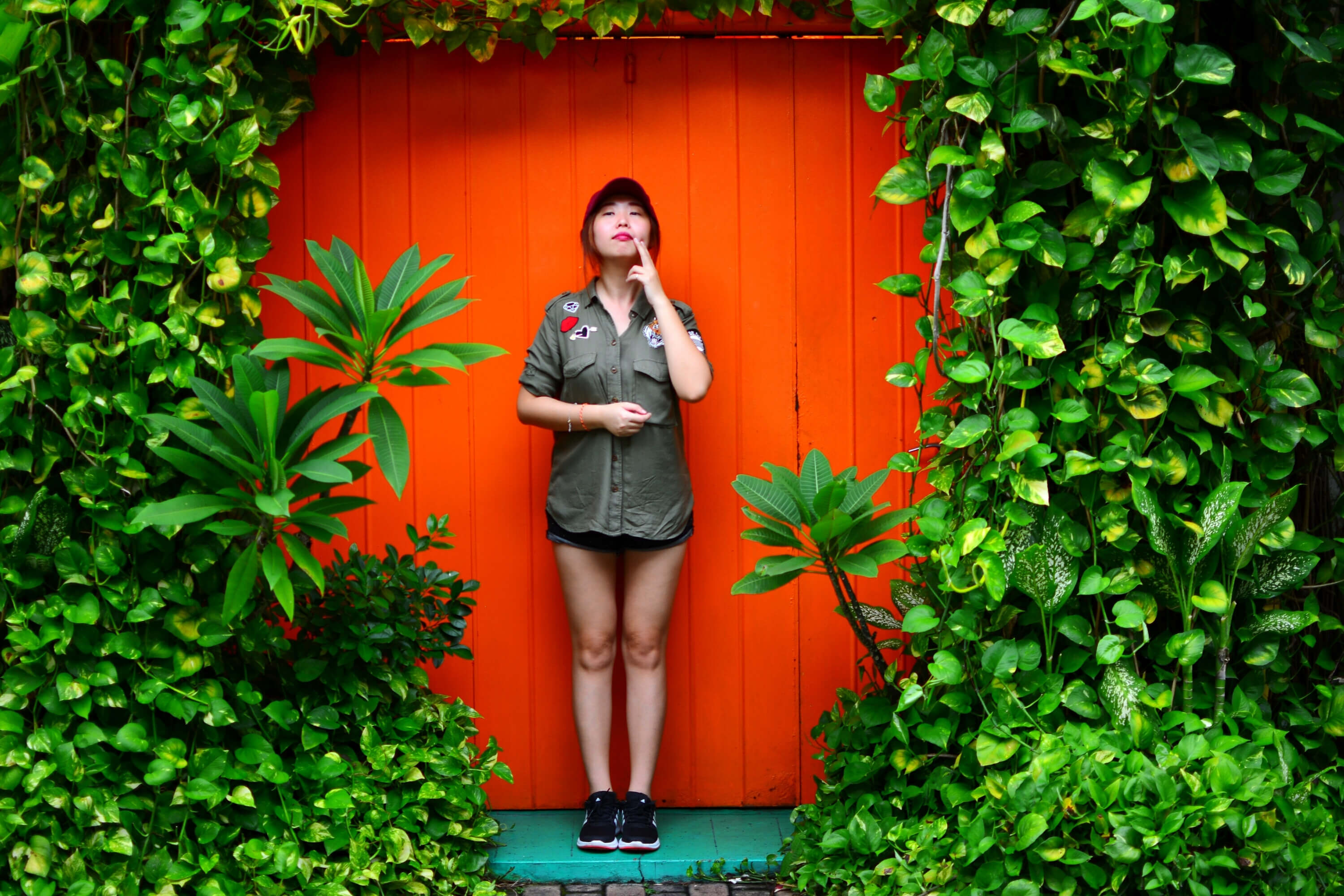 Girl Standing In Front of Red Door with Ivy 