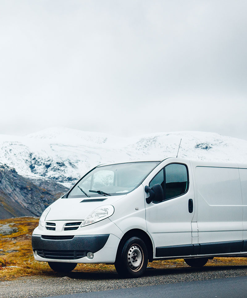 Van parked in front of a snowy mountain