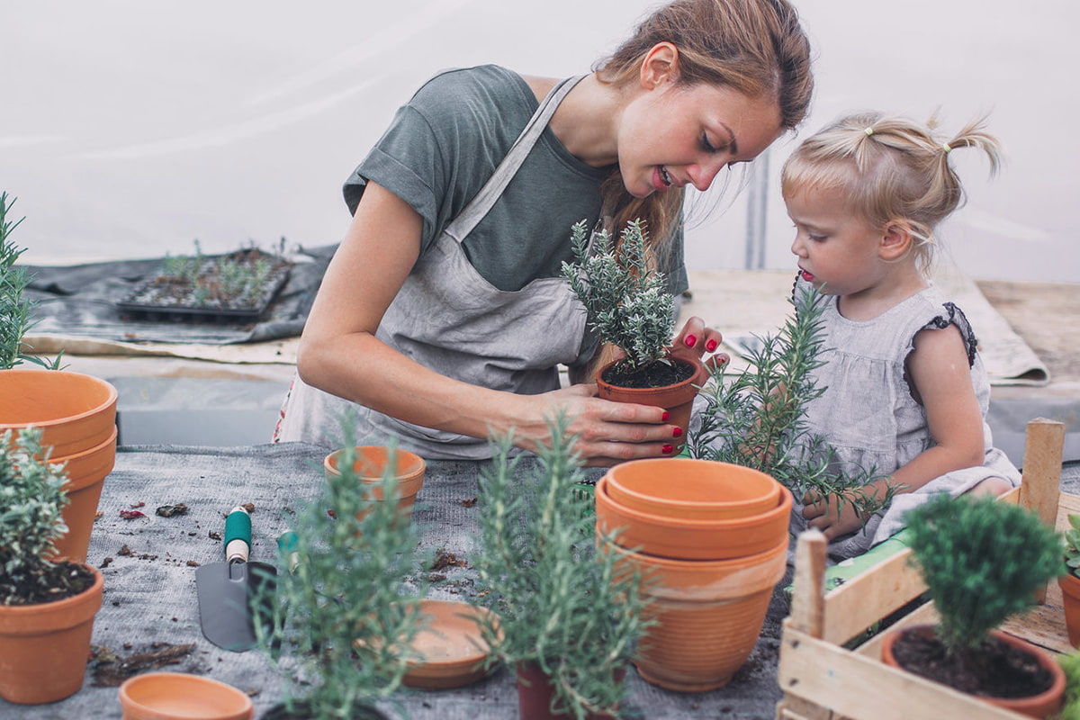 Woman and child potting plants