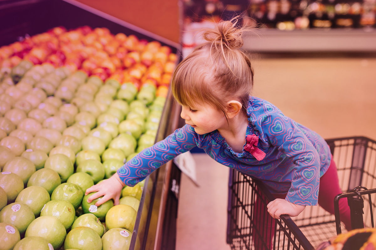 Little girl in a shopping cart