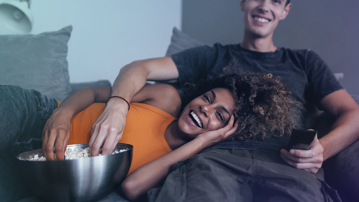 Couple watching a movie with popcorn