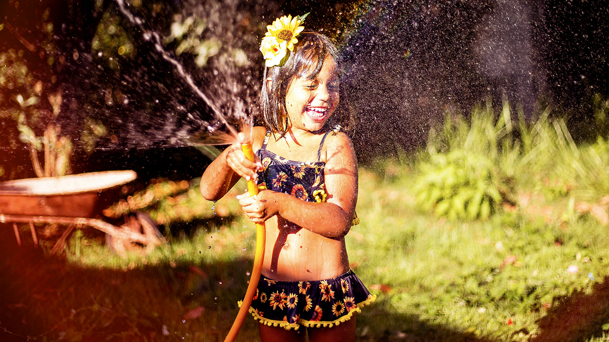 girl playing with hose