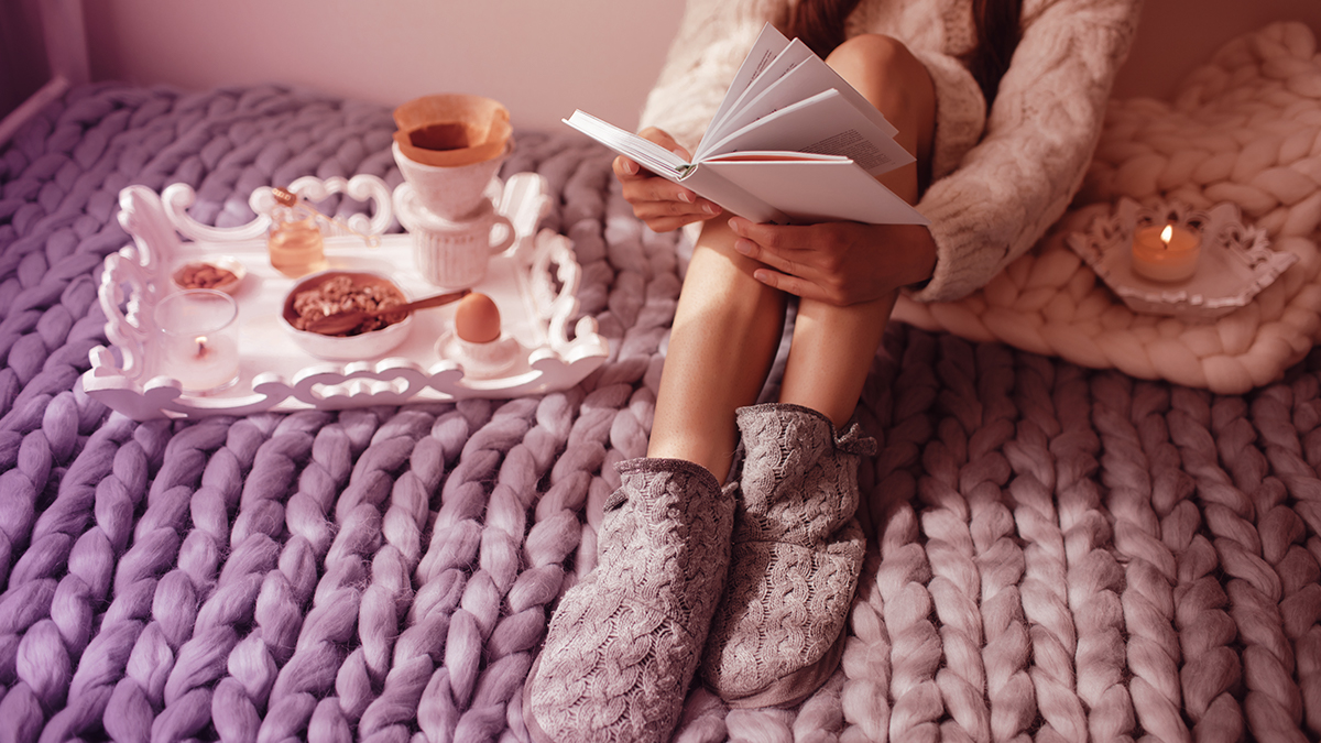 Woman wearing slippers and reading